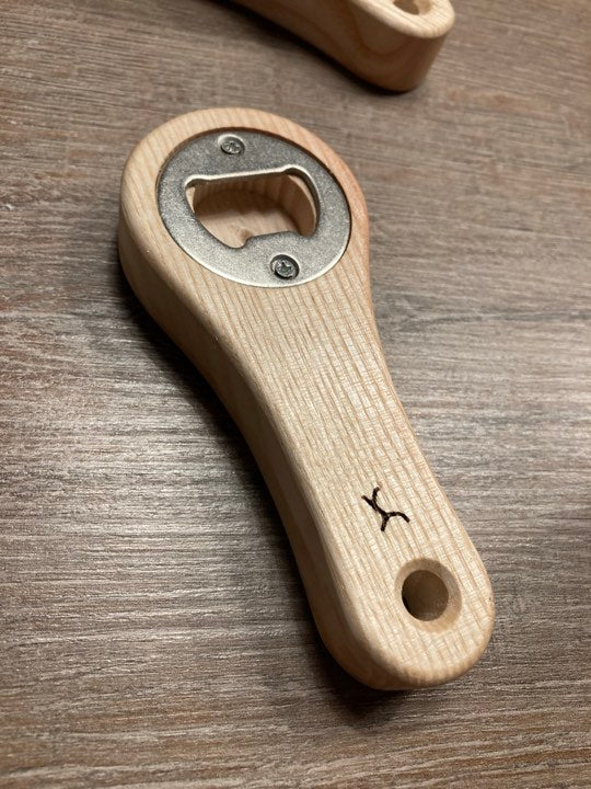 Customizable manual bottle opener in solid ash wood